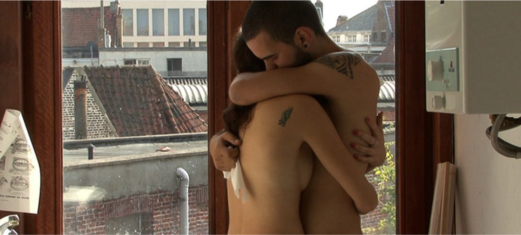 Wim Van Damme and Floor Wyns hug in the bathroom in in Skin.Like.Sun. (Des Jours), an erotic documentary movie directed by Jennifer Lyon Bell and Murielle Scherre available at Blue Artichoke Films